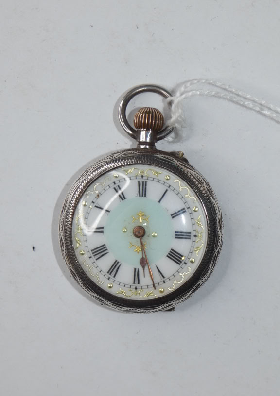A vintage pocket watch with a white face, Roman numerals, and a metal casing, attached to a white string.