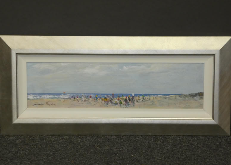 Framed painting of a beach scene with people on the sand and the ocean in the background.