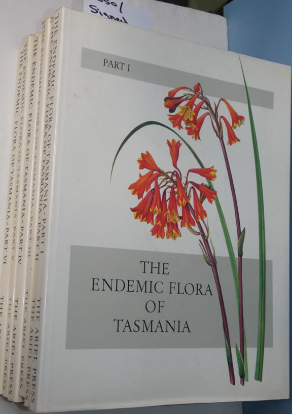 A stack of books titled "The Endemic Flora of Tasmania" with an illustration of red flowers on the cover.