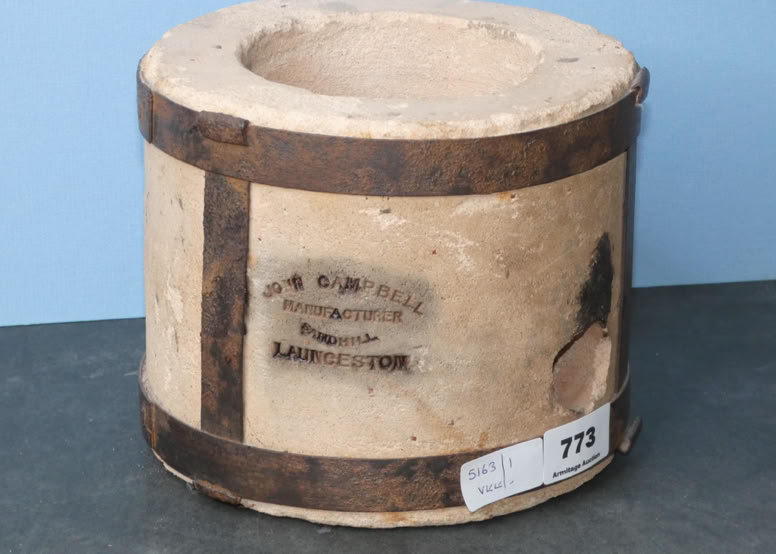 A cylindrical container with a rough, beige surface, reinforced by two dark bands, and a partially visible label with text.